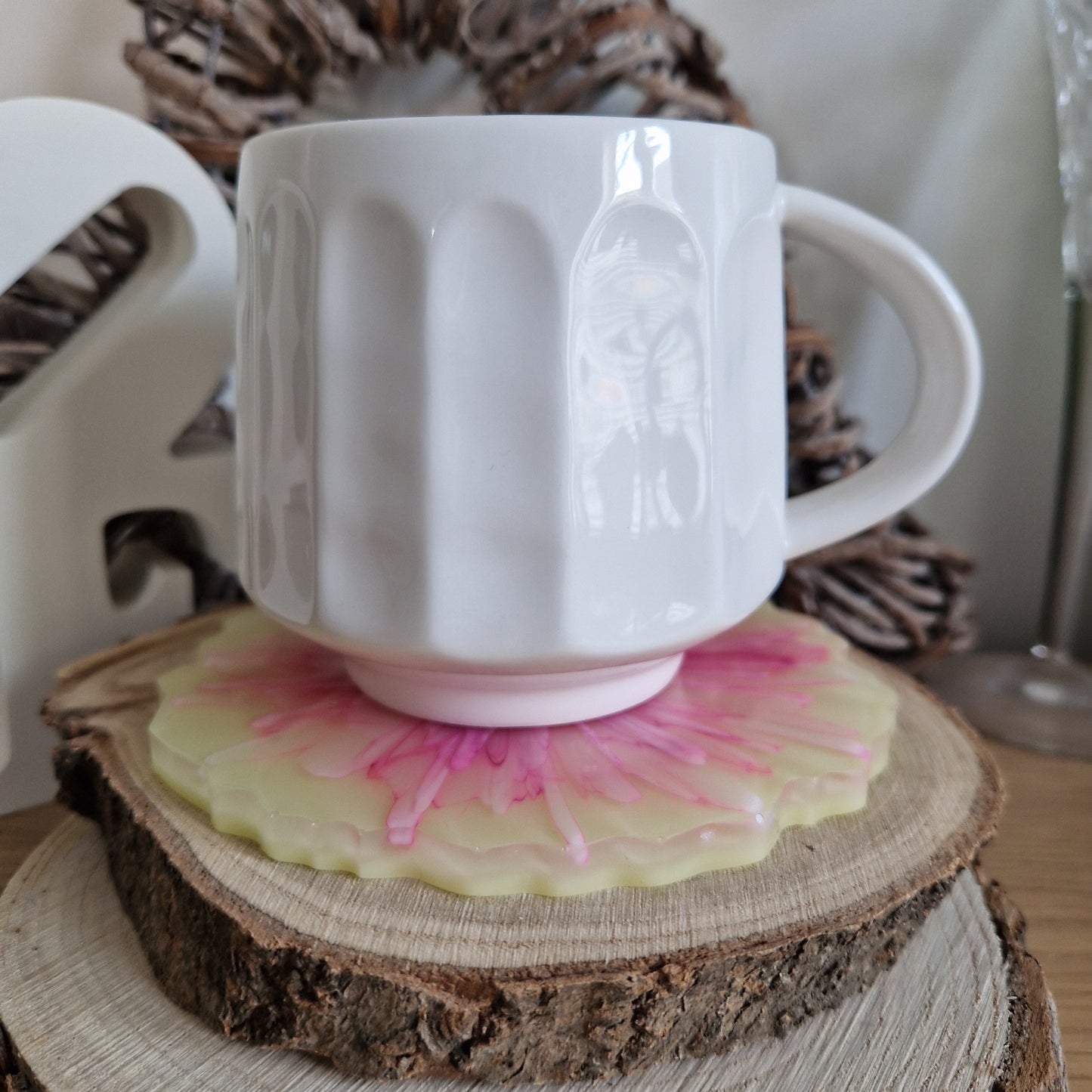 Resin bloom coasters with pink and yellow alcohol ink design