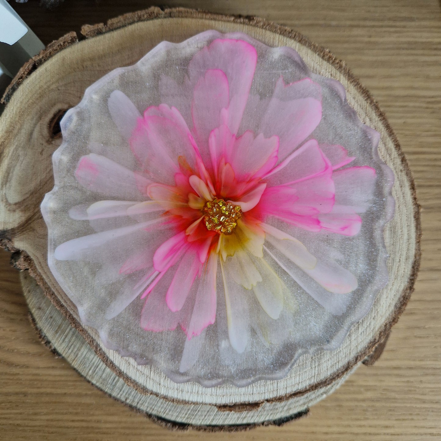 Resin bloom coaster with fuchsia and yellow alcohol ink design