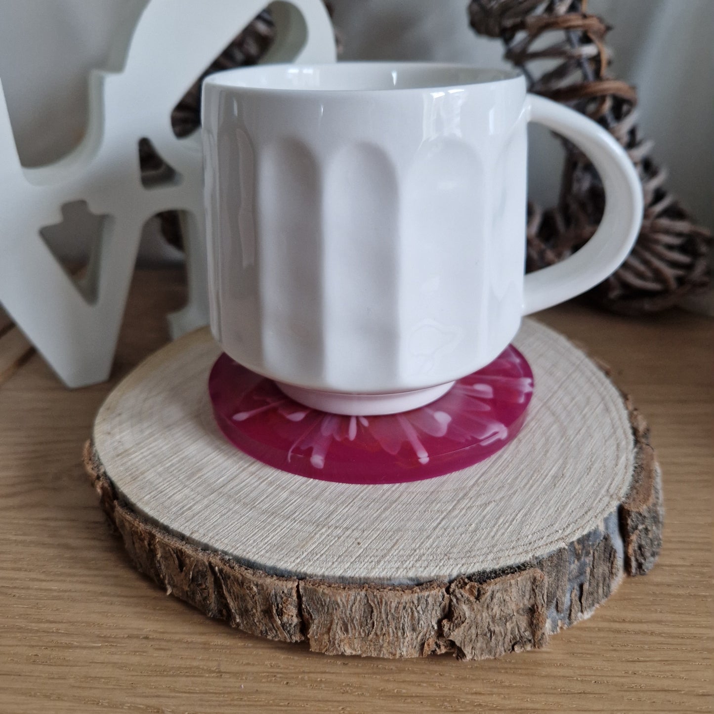 Resin bloom coaster with hot pink alcohol ink design