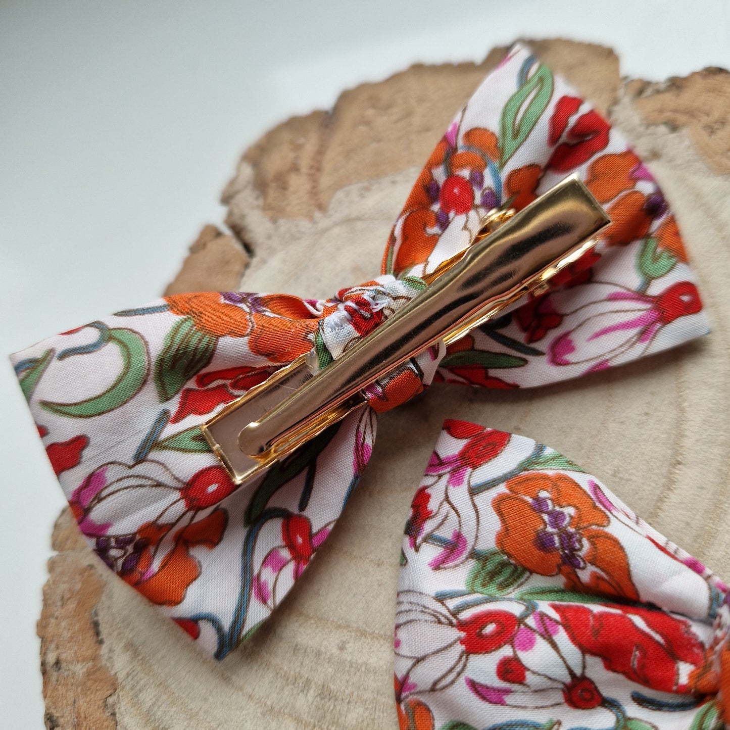 Pair of dinky vintage Liberty print hair bows in orange floral fabric