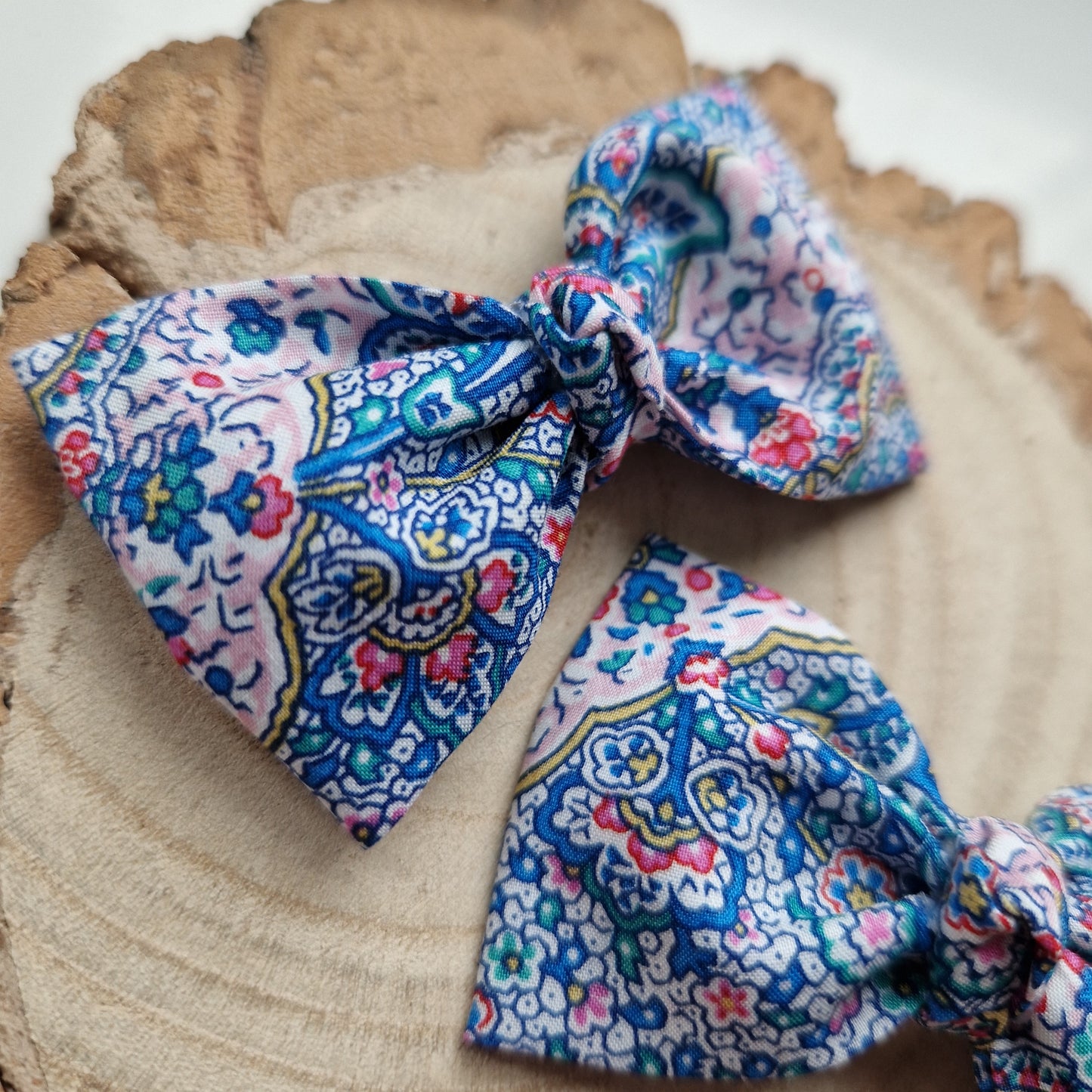 Pair of dinky vintage Liberty print hair bows in blue paisley fabric