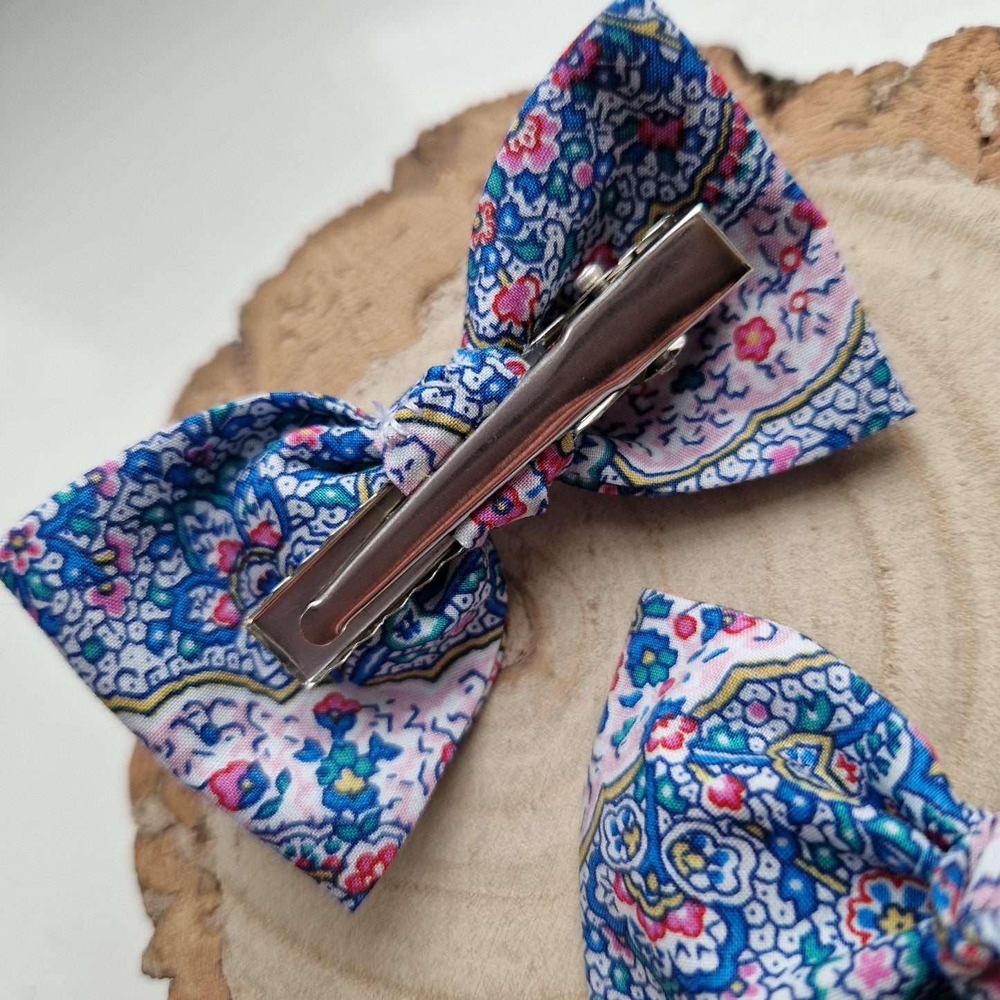 Pair of dinky vintage Liberty print hair bows in blue paisley fabric