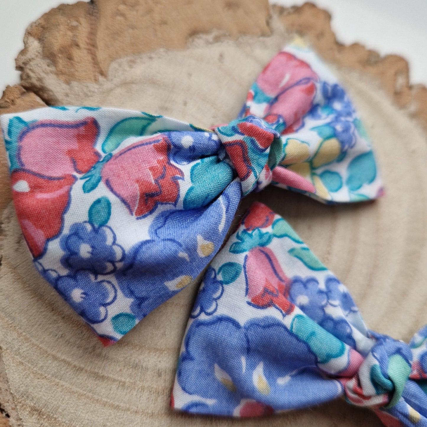 Pair of dinky vintage Liberty print hair bows in red and blue floral fabric
