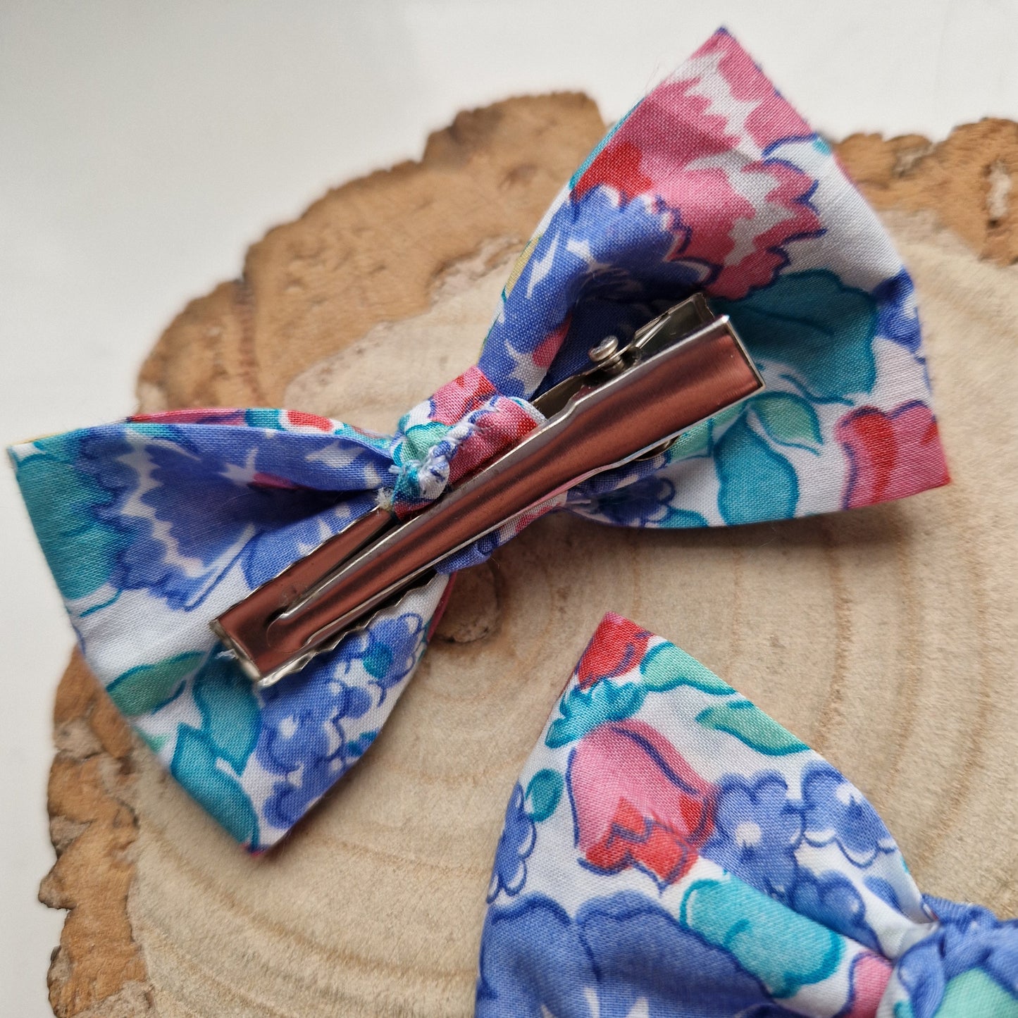 Pair of dinky vintage Liberty print hair bows in red and blue floral fabric