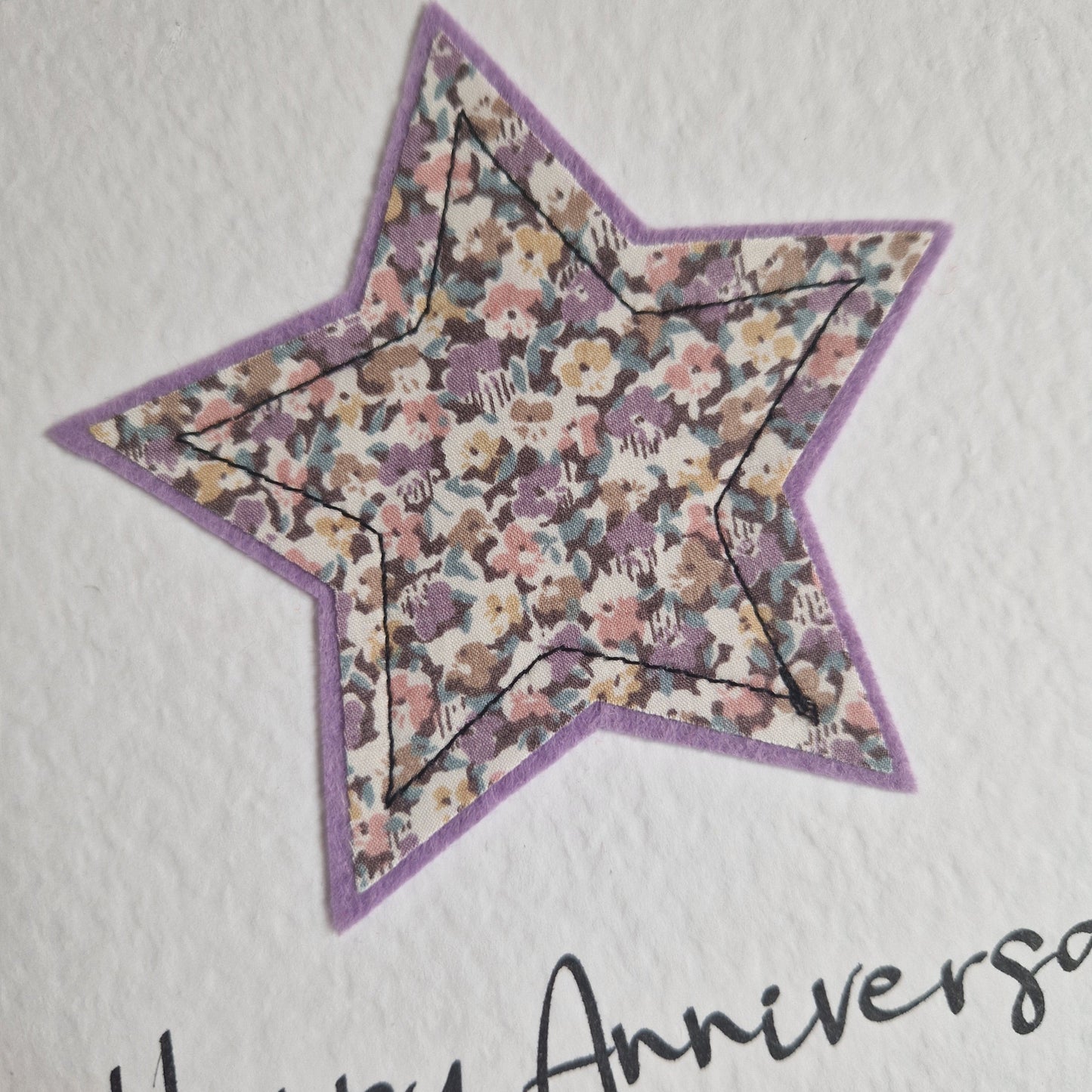 Vintage Liberty star card with a lilac floral star and happy anniversary sentiment