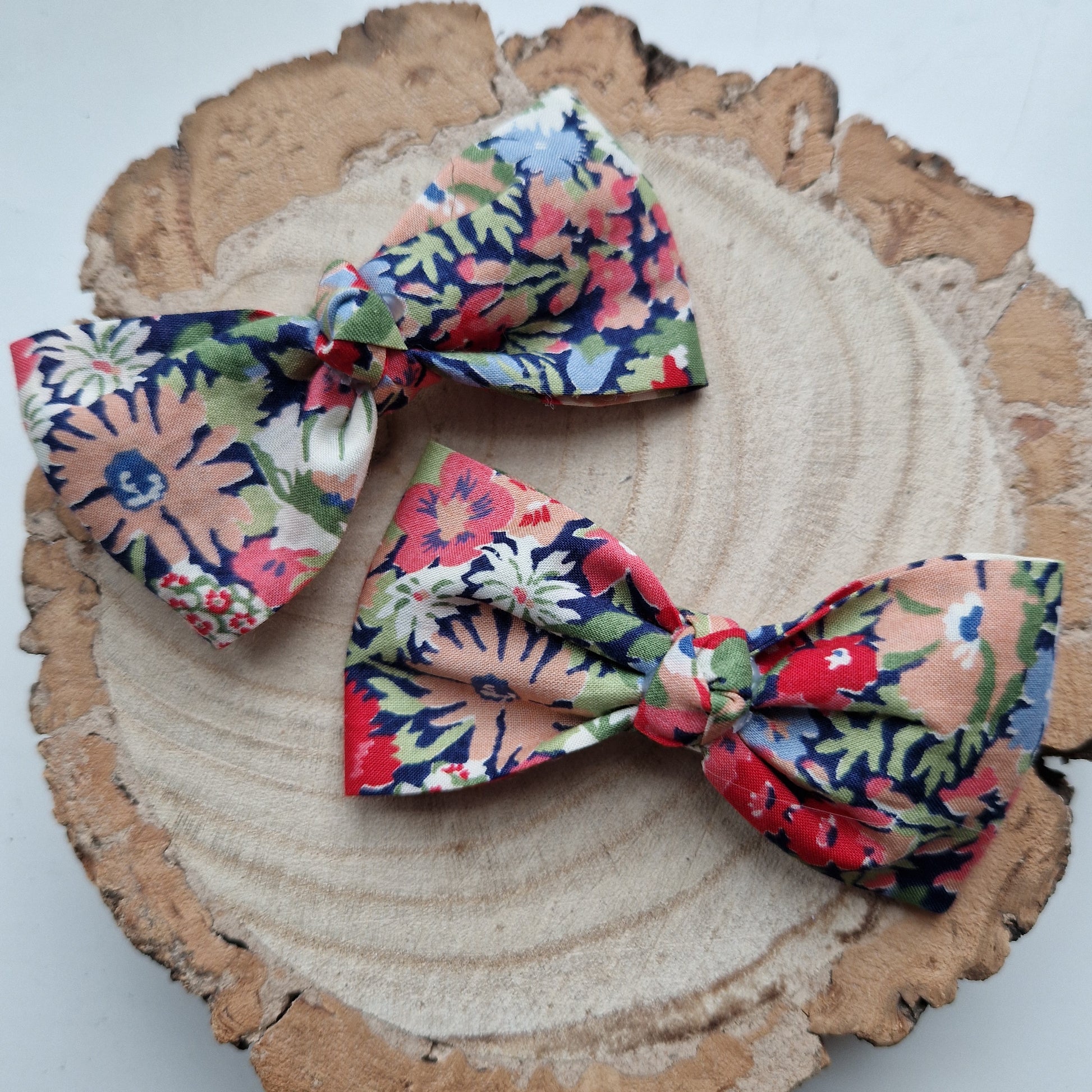 Pair of dinky vintage Liberty print hair bows in orange and grey floral fabric