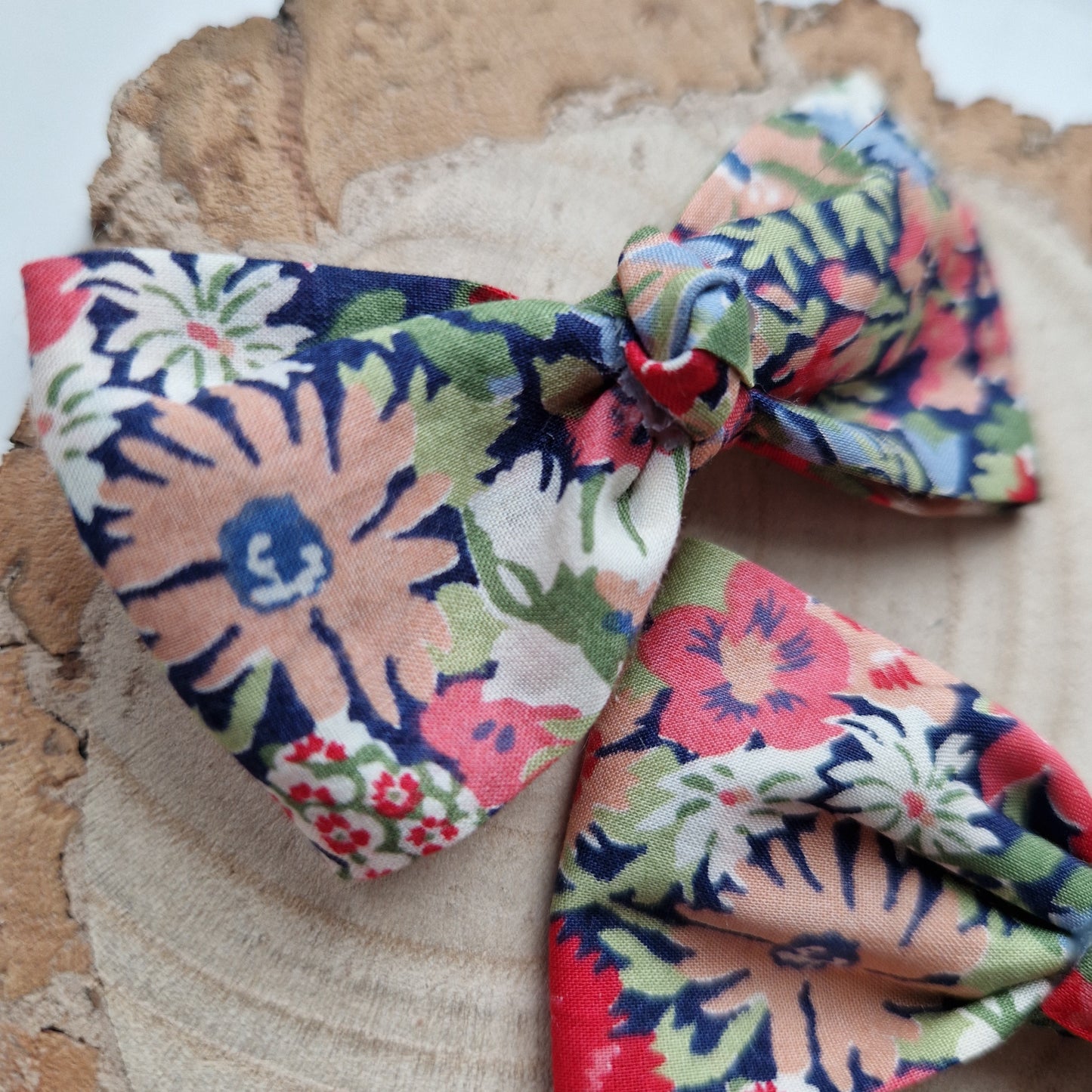 Pair of dinky vintage Liberty print hair bows in orange and grey floral fabric