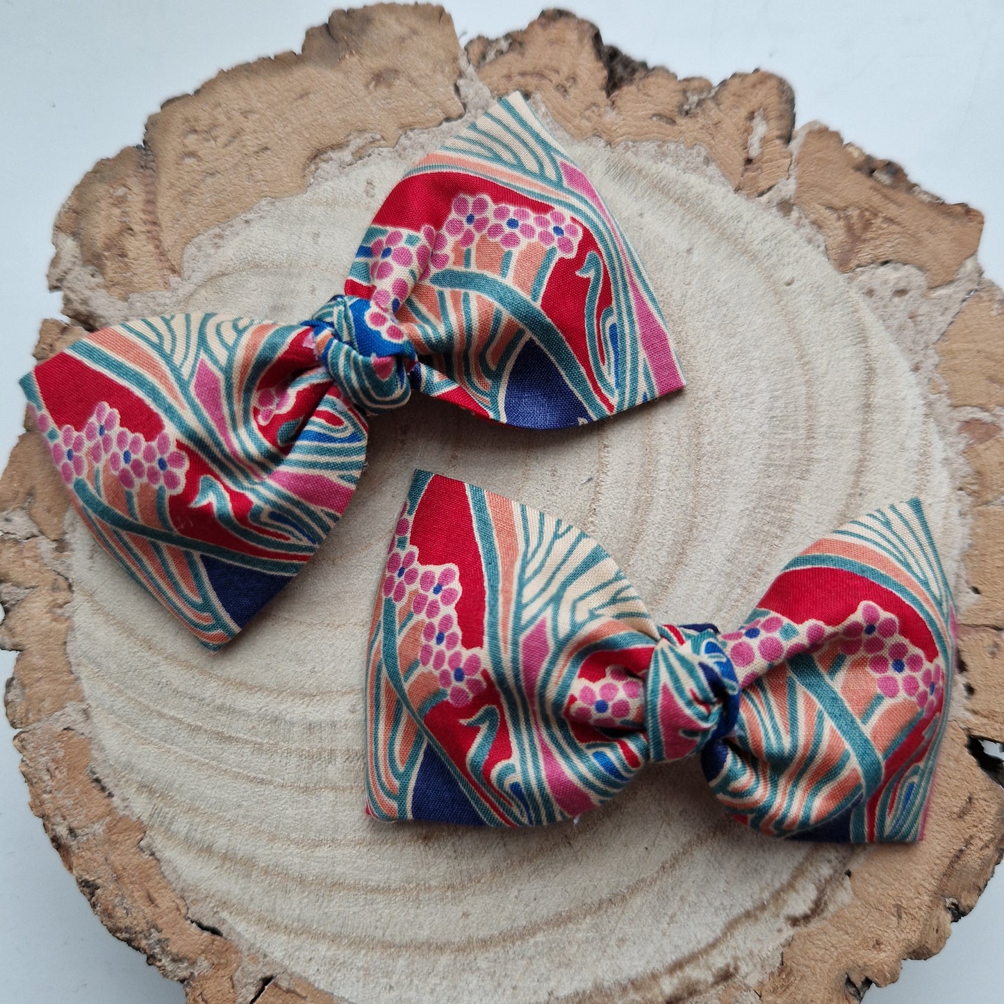 Pair of dinky vintage Liberty print hair bows in red and blue art deco fabric