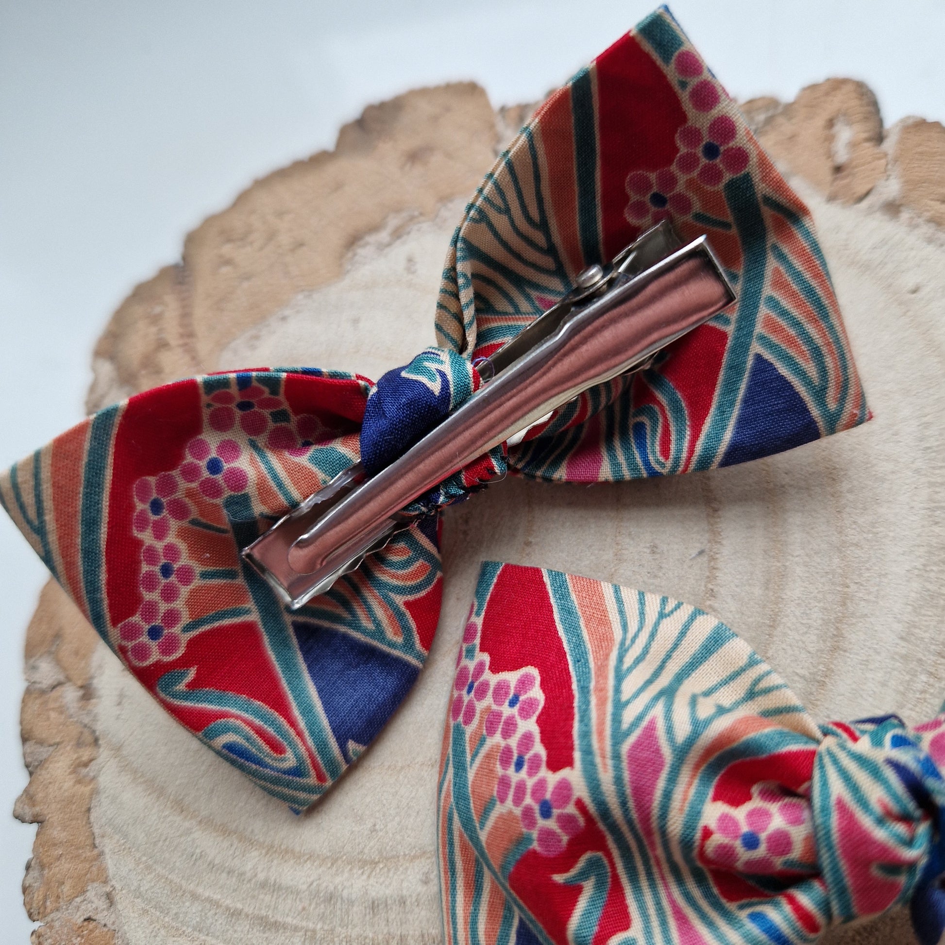 Pair of dinky vintage Liberty print hair bows in red and blue art deco fabric