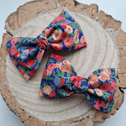 Pair of dinky vintage Liberty print hair bows in peach berry fabric